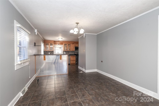 interior space with crown molding, dark tile patterned floors, and a chandelier