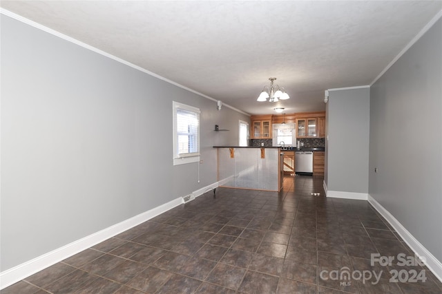 unfurnished living room featuring dark tile patterned floors, ornamental molding, sink, and an inviting chandelier