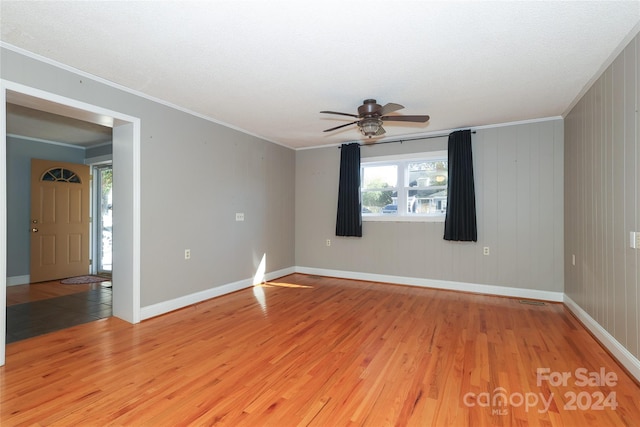 unfurnished room featuring ceiling fan, light hardwood / wood-style flooring, and ornamental molding