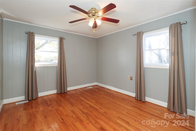 unfurnished room with ceiling fan, ornamental molding, and light wood-type flooring