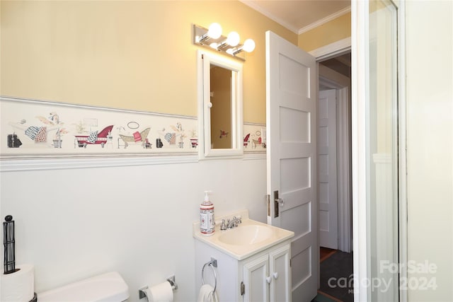 bathroom with walk in shower, crown molding, vanity, and toilet