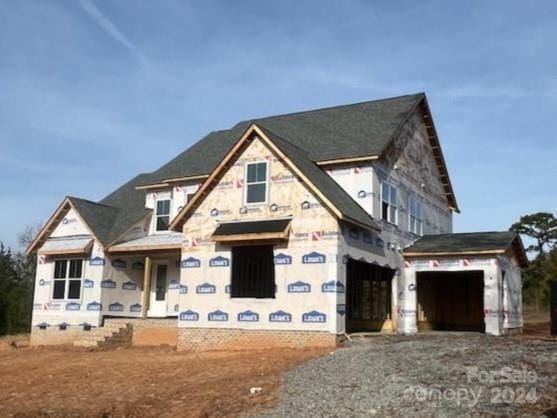 unfinished property featuring a garage