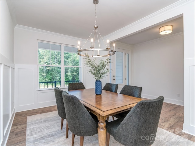 320 Triple Ponds Ct, Clover, SC 29710 - dining space with a chandelier, wood finished floors, crown molding, a decorative wall, and a wainscoted wall