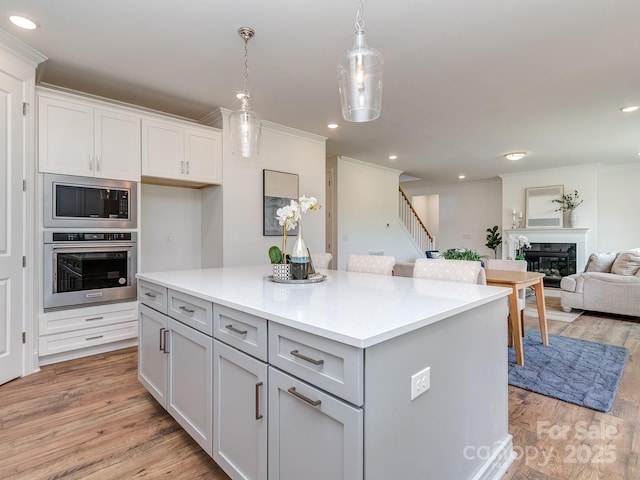 320 Triple Ponds Ct, Clover, SC 29710 - kitchen with appliances with stainless steel finishes, crown molding, light wood-type flooring, light countertops, and recessed lighting