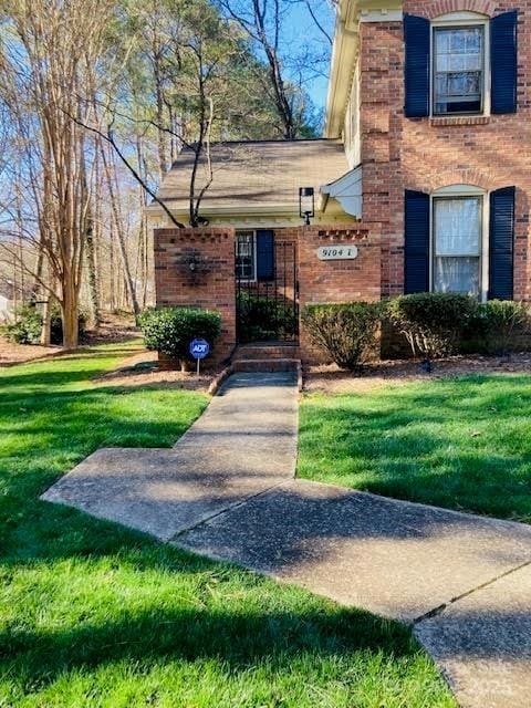 view of exterior entry with a lawn