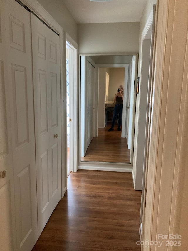 hallway with dark wood-type flooring