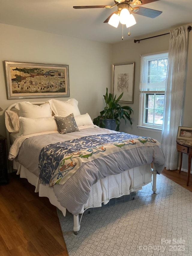 bedroom featuring wood-type flooring and ceiling fan