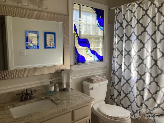 bathroom with vanity, toilet, and walk in shower