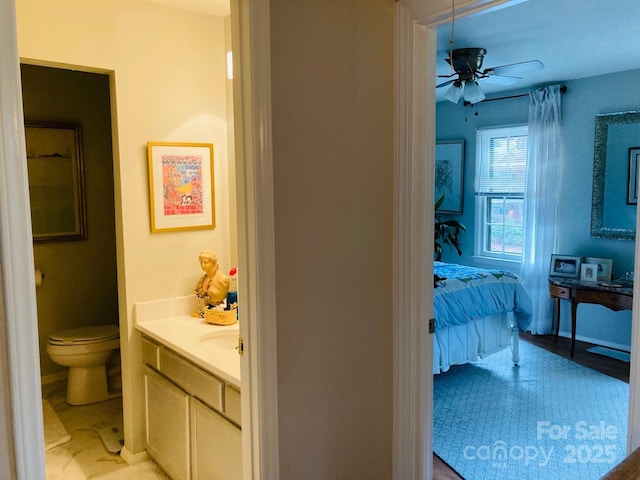 bathroom with ceiling fan, vanity, and toilet