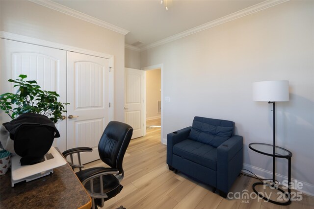 office area with light hardwood / wood-style flooring and crown molding