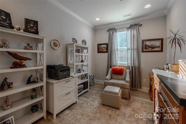 living area with light hardwood / wood-style floors and ornamental molding