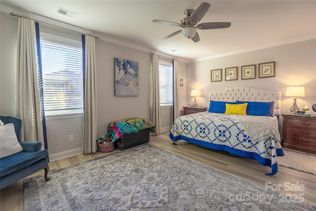 bedroom featuring ceiling fan, hardwood / wood-style floors, and ornamental molding