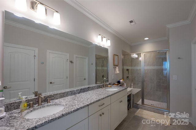 bathroom with a shower with door, vanity, ornamental molding, and tile patterned flooring