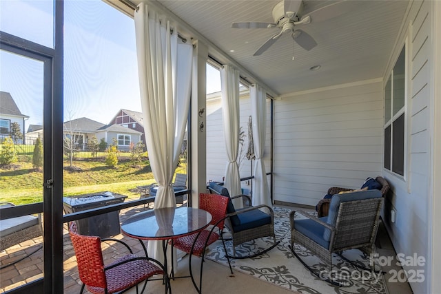 sunroom / solarium featuring ceiling fan