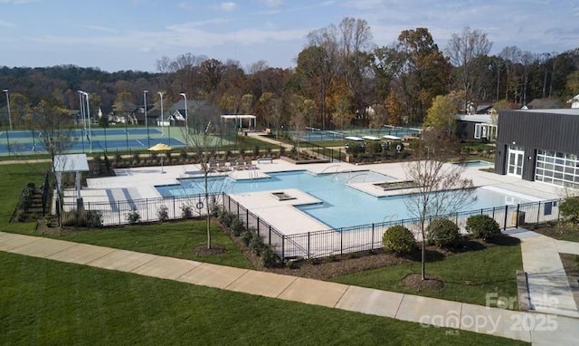 view of swimming pool with a lawn and a patio