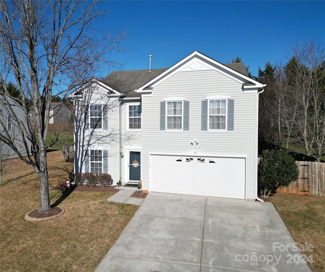 view of front of home with a garage and a front yard