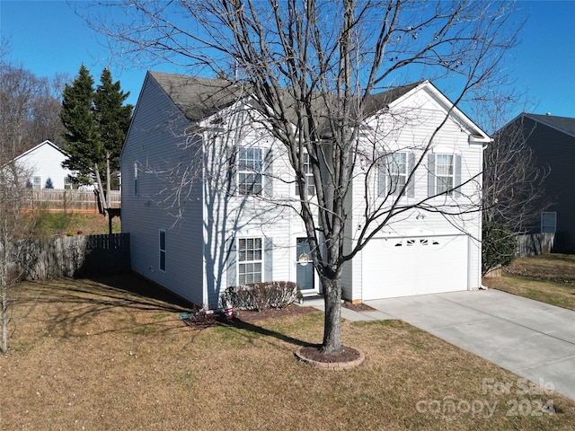 view of front of house with a garage and a front lawn