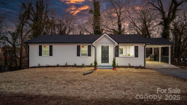 single story home featuring a carport