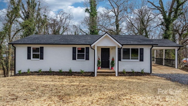 ranch-style home featuring a carport