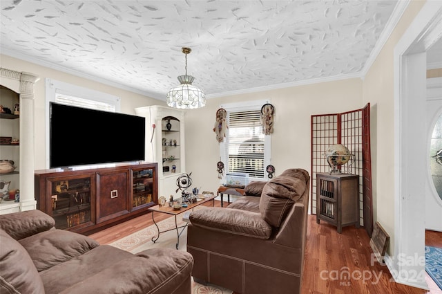 living room with a textured ceiling, hardwood / wood-style flooring, built in features, and crown molding