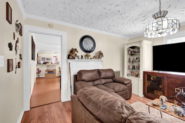 living room featuring a fireplace, wood-type flooring, a textured ceiling, and ornamental molding