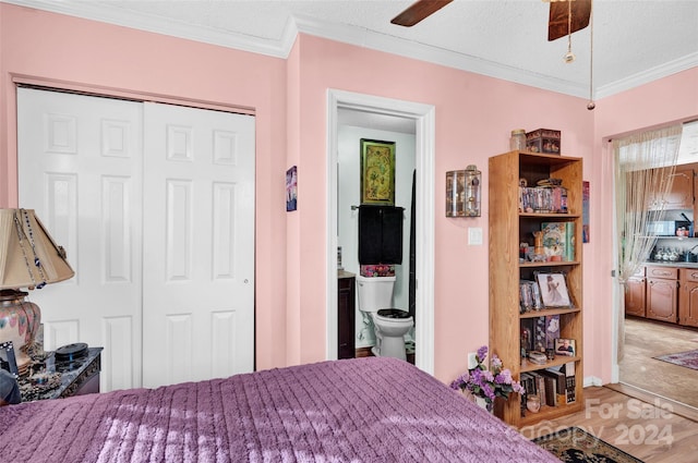 bedroom with a textured ceiling, a closet, ceiling fan, and crown molding