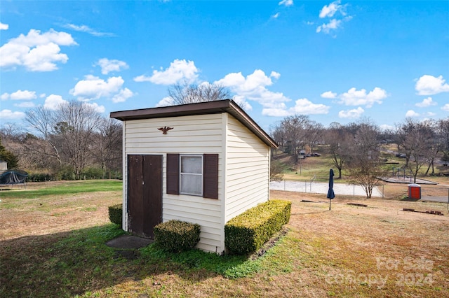 view of outbuilding featuring a lawn