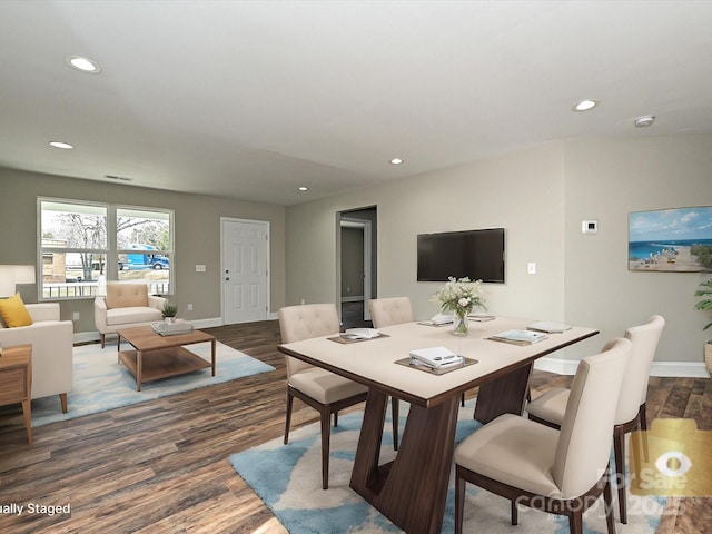 dining room featuring dark wood-type flooring, recessed lighting, and baseboards