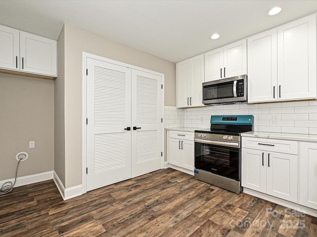 kitchen with white cabinetry, stainless steel appliances, and light countertops