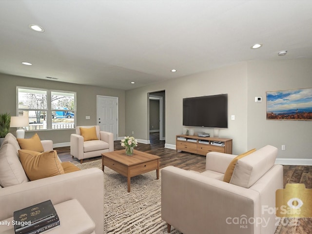 living room with baseboards, wood finished floors, visible vents, and recessed lighting