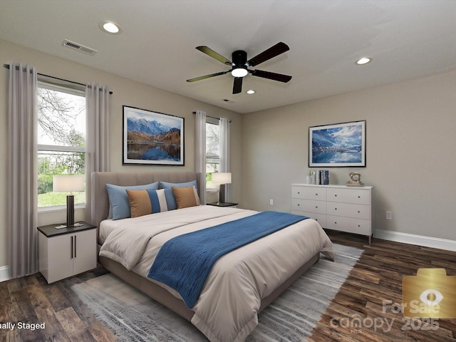 bedroom with dark wood-style floors, recessed lighting, and visible vents