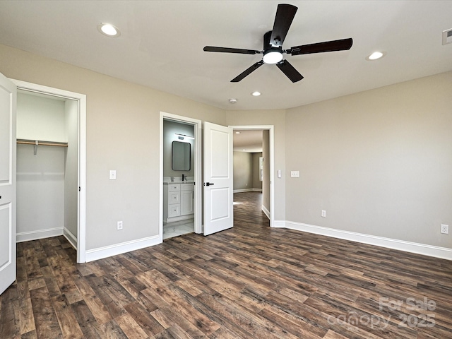 unfurnished bedroom with dark wood-style floors, baseboards, and recessed lighting