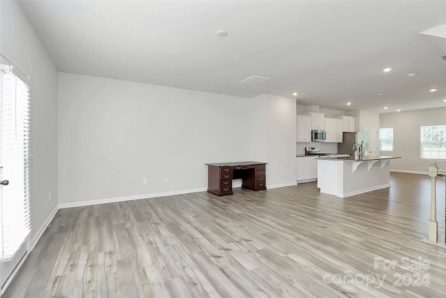 unfurnished living room with light hardwood / wood-style flooring