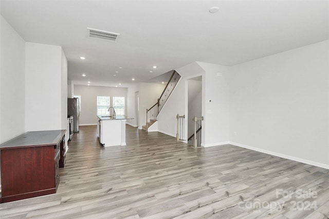 interior space featuring sink and light hardwood / wood-style flooring