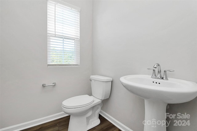 bathroom featuring hardwood / wood-style flooring and toilet