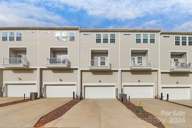 exterior space featuring central air condition unit and a garage