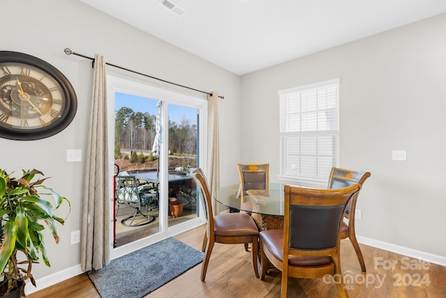 dining room featuring a healthy amount of sunlight and hardwood / wood-style flooring