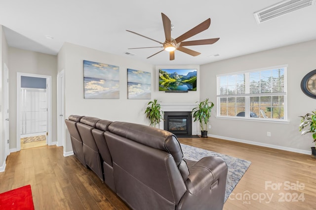 living room with wood-type flooring and ceiling fan