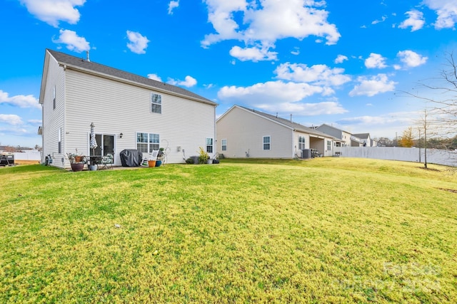 rear view of property with a patio and a lawn