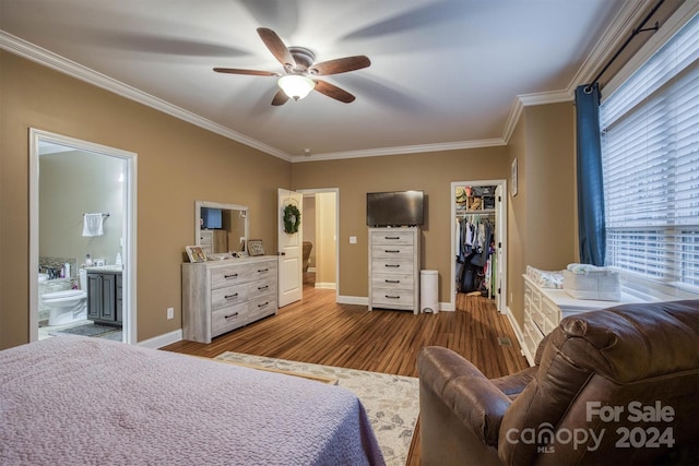 bedroom with ensuite bathroom, ceiling fan, wood-type flooring, a spacious closet, and a closet