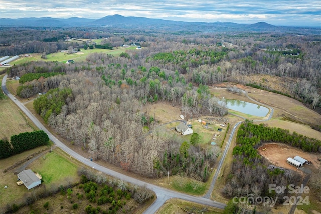 aerial view featuring a water and mountain view