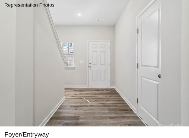 hallway with hardwood / wood-style floors