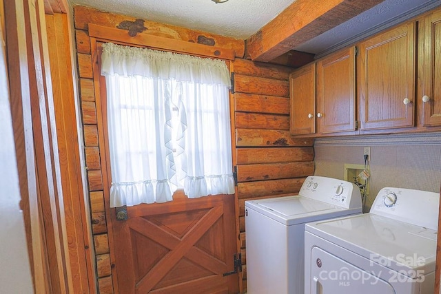 laundry area featuring separate washer and dryer, log walls, cabinets, and a textured ceiling