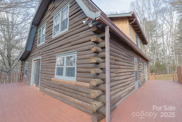 view of property exterior featuring a wooden deck