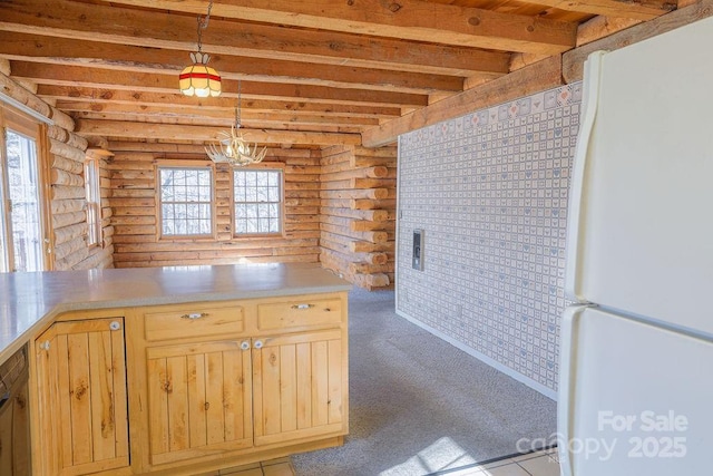 kitchen with rustic walls, hanging light fixtures, beam ceiling, light colored carpet, and white fridge