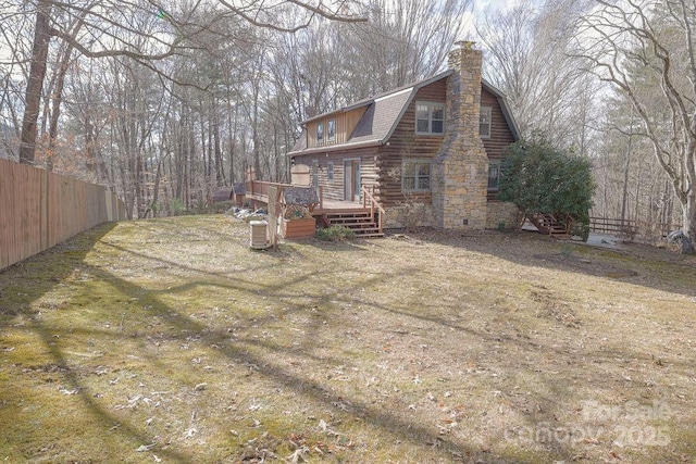 exterior space featuring a deck and a lawn