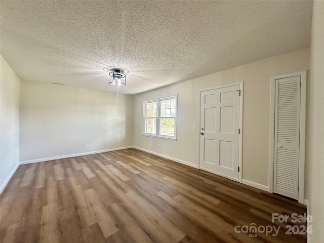 interior space featuring hardwood / wood-style floors and a textured ceiling