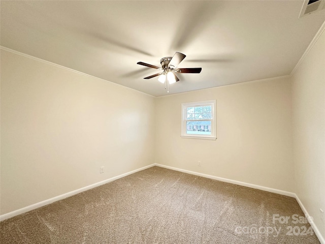 carpeted empty room with ceiling fan and ornamental molding