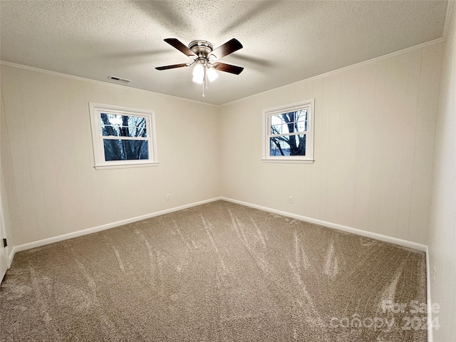 unfurnished room with crown molding, carpet, a textured ceiling, and ceiling fan