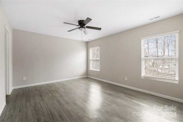 empty room featuring ceiling fan and dark hardwood / wood-style flooring